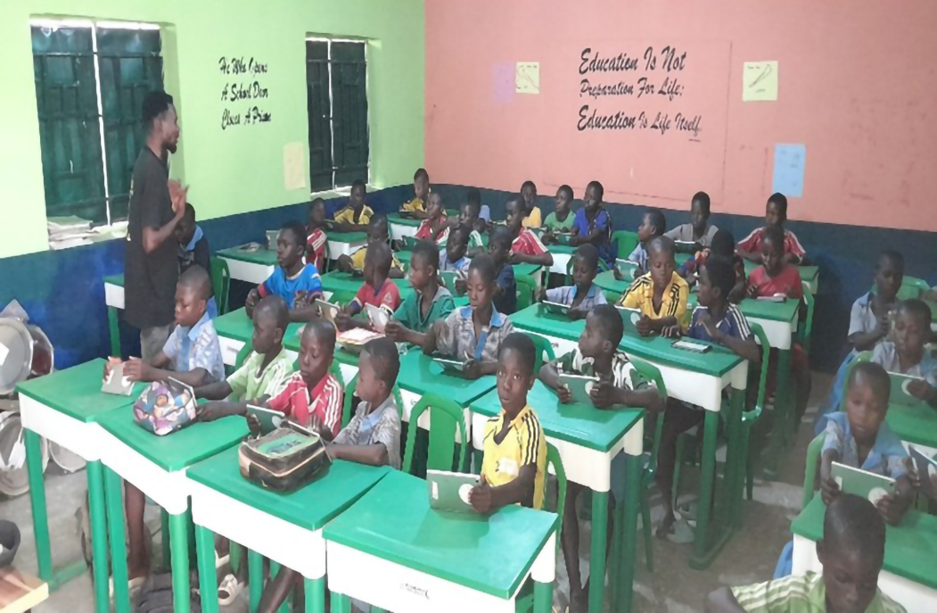 Cross-section of learners using their digital devices on the UNHCR – Profuturo project 3